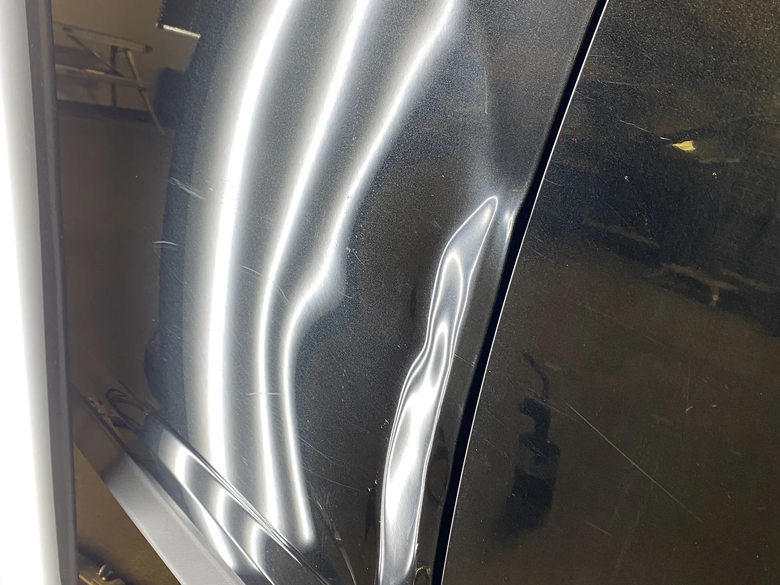 Dented door before paintless dent repair