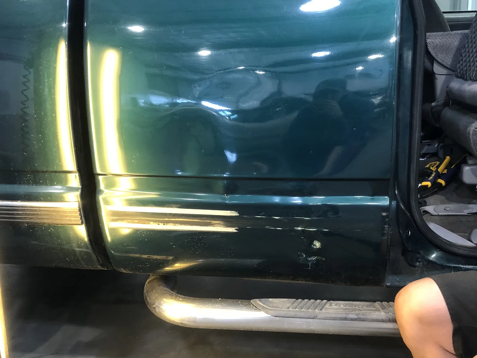Green truck door after paintless dent repair by SFR