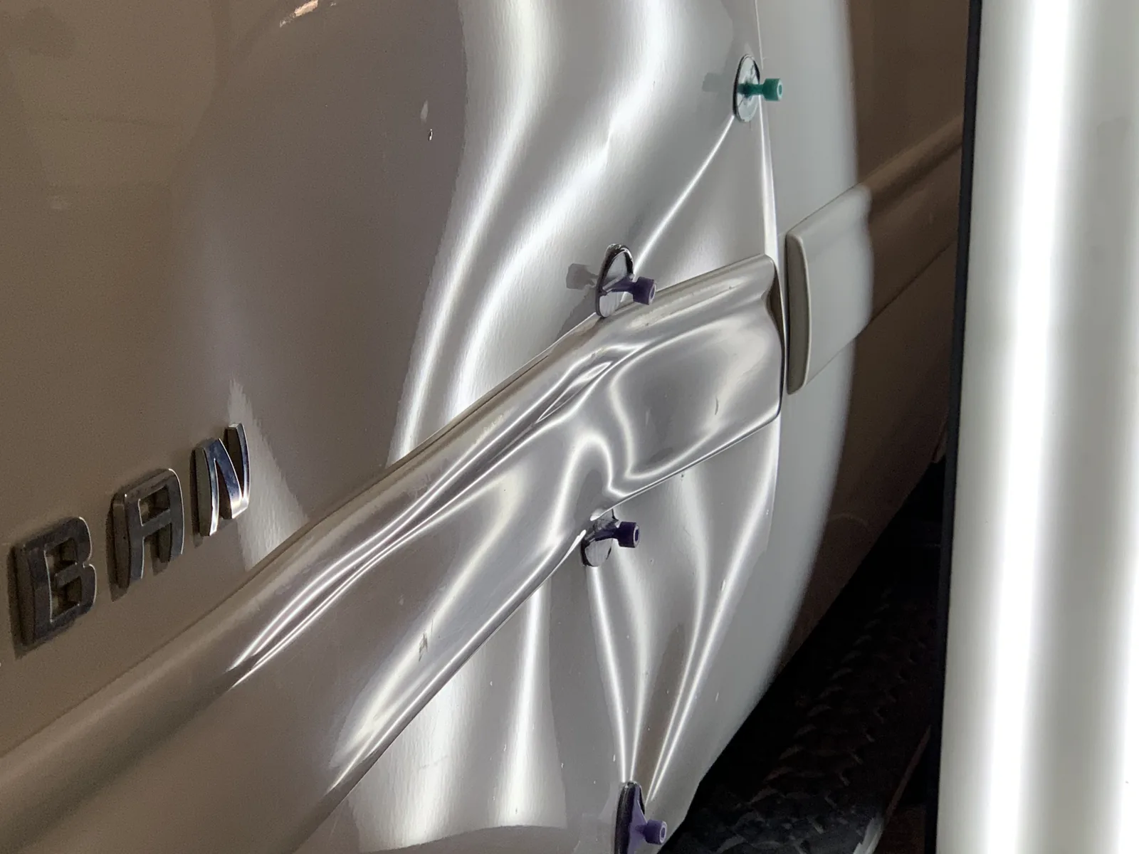 Chevrolet Suburban door dent before paintless dent repair