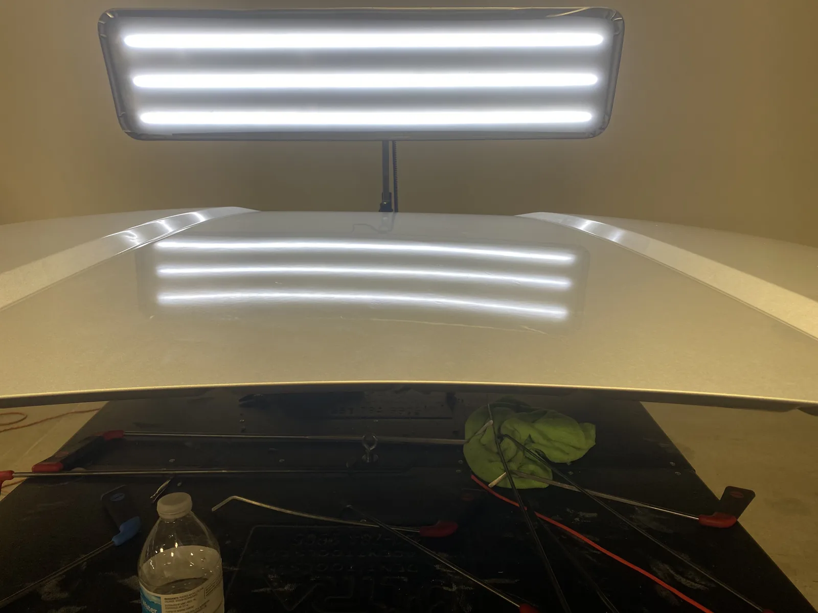 White hood after paintless dent repair, reflection board check