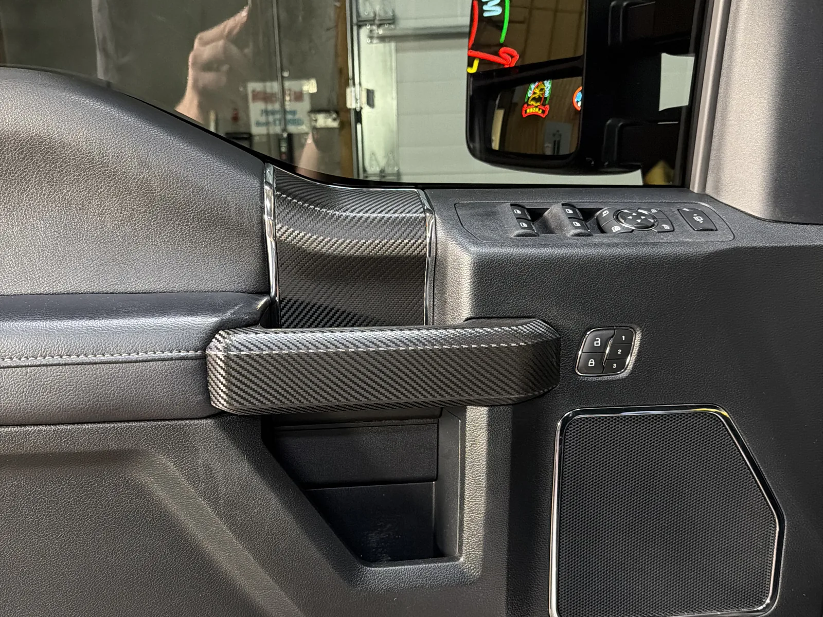 Truck interior door after custom carbon-fiber trim overlay by SFR